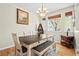 Dining room features hardwood floors, a chandelier, and large windows at 17808 E 104Th Pl # C, Commerce City, CO 80022