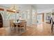 Elegant dining room featuring hardwood floors, a chandelier, and a stylish table with seating for four at 17808 E 104Th Pl # C, Commerce City, CO 80022