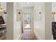 Inviting foyer with hardwood floors, a patterned rug, and a view of the front yard through the open door at 17808 E 104Th Pl # C, Commerce City, CO 80022