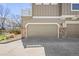 Two-car garage in a multi-unit townhome property with a brick facade at 17808 E 104Th Pl # C, Commerce City, CO 80022