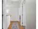 Upstairs hallway with hardwood floors and view into the bedroom at 17808 E 104Th Pl # C, Commerce City, CO 80022