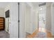This hallway features a TV, an open doorway, and leads to a room with sunlit windows at 17808 E 104Th Pl # C, Commerce City, CO 80022