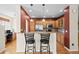 Kitchen includes stainless steel appliances, wooden cabinets, granite countertops and bar seating at 17808 E 104Th Pl # C, Commerce City, CO 80022