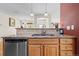 Kitchen sink with granite countertops, stainless steel dishwasher, and adjacent open floor plan at 17808 E 104Th Pl # C, Commerce City, CO 80022