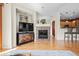 Spacious living room featuring a fireplace, hardwood floors, and an open layout to the kitchen at 17808 E 104Th Pl # C, Commerce City, CO 80022