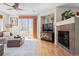 Cozy living room with a fireplace, hardwood floors, and sliding glass doors leading to the outdoors at 17808 E 104Th Pl # C, Commerce City, CO 80022