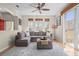 Inviting living room with a sectional sofa, hardwood floors, and natural light from the windows at 17808 E 104Th Pl # C, Commerce City, CO 80022