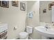 The powder room features a pedestal sink, artwork, and a wall-mounted towel rack at 17808 E 104Th Pl # C, Commerce City, CO 80022