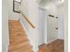A wooden staircase leads to the second floor with a white door at the landing at 17808 E 104Th Pl # C, Commerce City, CO 80022