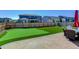 Fenced backyard with artificial grass, putting green, and outdoor dining area, perfect for outdoor living at 14290 Hop Clover St, Parker, CO 80134