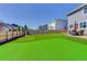 Large backyard with artificial turf, privacy fence, putting green, and outdoor dining, great for entertainment at 14290 Hop Clover St, Parker, CO 80134