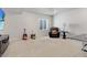 Spacious basement area with seating, guitars, neutral carpet and a ping pong table at 14290 Hop Clover St, Parker, CO 80134