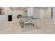 Open basement space with a neutral carpet, ping pong table, and a door leading to another room at 14290 Hop Clover St, Parker, CO 80134