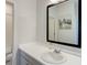 Bathroom featuring a white countertop, vanity with modern faucet, and a framed mirror at 14290 Hop Clover St, Parker, CO 80134