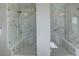 This bathroom has dual walk-in showers with luxurious tile and glass doors at 14290 Hop Clover St, Parker, CO 80134
