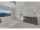 Bright bedroom features an ensuite bathroom, ceiling fan, and dresser at 14290 Hop Clover St, Parker, CO 80134