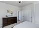 Bright bedroom with a dresser, white walls, closet with sliding doors and neutral carpet at 14290 Hop Clover St, Parker, CO 80134