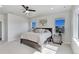 Sun-filled bedroom showcasing a large bed, two windows, and a ceiling fan at 14290 Hop Clover St, Parker, CO 80134