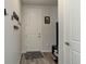 Clean entryway featuring wood flooring, a coat rack and a small rug by the front door at 14290 Hop Clover St, Parker, CO 80134