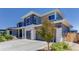 Beautiful two-story home featuring gray siding, white stone accents, and a three-car garage at 14290 Hop Clover St, Parker, CO 80134