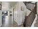 Bright hallway with wood floors leading to an open-concept living area and staircase with wood banister at 14290 Hop Clover St, Parker, CO 80134