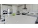 A bright kitchen features a large island with a white countertop, stainless steel appliances, and modern cabinets at 14290 Hop Clover St, Parker, CO 80134