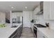 A modern kitchen with stainless steel appliances, granite countertops and gray cabinets, perfect for entertaining at 14290 Hop Clover St, Parker, CO 80134