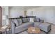 A modern living room features a large sectional couch, neighborhood views, and is well-lit by natural light at 14290 Hop Clover St, Parker, CO 80134