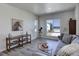 A modern living room features a large sectional couch, neighborhood views, and is well-lit by natural light at 14290 Hop Clover St, Parker, CO 80134