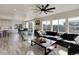 Bright living room with large windows, wood floors, and modern furnishings at 14290 Hop Clover St, Parker, CO 80134