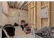 Unfinished basement showing exposed beams, wires, plastic covered walls, and storage items at 14290 Hop Clover St, Parker, CO 80134