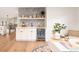 Chic bar area with white cabinetry, sleek countertops, stylish backsplash and beverage refrigerator at 3147 Juniper Ct, Golden, CO 80401