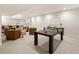 Finished basement with ping pong table, bar area, and comfortable seating at 3147 Juniper Ct, Golden, CO 80401