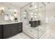 Updated bathroom features a frameless glass shower with a bench, dual vanities and modern fixtures at 3147 Juniper Ct, Golden, CO 80401
