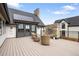 Deck with a stone fireplace, outdoor seating and views of the backyard and surrounding landscape at 3147 Juniper Ct, Golden, CO 80401