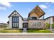 Stunning two-story home with a stone facade and modern architectural details in a manicured lawn at 3147 Juniper Ct, Golden, CO 80401