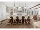 Modern kitchen featuring a large island, stylish bar stools, and custom cabinetry with glass accents at 3147 Juniper Ct, Golden, CO 80401