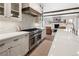 Modern kitchen with custom cabinets, stainless appliances, and quartz countertops overlooking the living room at 3147 Juniper Ct, Golden, CO 80401