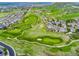 Stunning aerial perspective highlighting the property's proximity to the lush green golf course and beautiful natural surroundings at 2833 Open Sky Way, Castle Rock, CO 80109