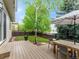 Inviting backyard featuring a wooden deck, mature trees, and a well-maintained lawn at 2833 Open Sky Way, Castle Rock, CO 80109