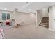 Finished basement featuring neutral carpet, stairs, and a window bringing in natural light at 2833 Open Sky Way, Castle Rock, CO 80109