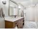 Modern bathroom featuring a wood vanity with a quartz countertop and a walk-in shower at 2833 Open Sky Way, Castle Rock, CO 80109