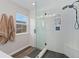 Modern bathroom featuring a walk-in shower with glass doors, black fixtures, and a bench at 2833 Open Sky Way, Castle Rock, CO 80109