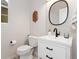 Stylish half bath features a modern vanity, black faucet, decorative mirror, and eye-catching accent wall at 2833 Open Sky Way, Castle Rock, CO 80109
