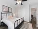 Comfortable bedroom showcasing a black metal bed frame, ceiling fan, and natural light at 2833 Open Sky Way, Castle Rock, CO 80109