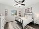 Bright bedroom featuring a black metal bed frame, ceiling fan, and ample natural light at 2833 Open Sky Way, Castle Rock, CO 80109