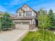 Charming two-story home featuring a two-car garage, classic tudor detailing, and a well-manicured front yard at 2833 Open Sky Way, Castle Rock, CO 80109