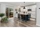Stylish kitchen with stainless steel appliances, island seating, and sliding glass doors to the outdoor patio at 2833 Open Sky Way, Castle Rock, CO 80109