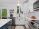 Well-lit kitchen featuring white countertops and cabinets, stainless steel appliances, and a garden window at 2833 Open Sky Way, Castle Rock, CO 80109