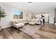 Bright living room showcases a large sectional sofa, stylish rug, and open layout to the modern kitchen at 2833 Open Sky Way, Castle Rock, CO 80109